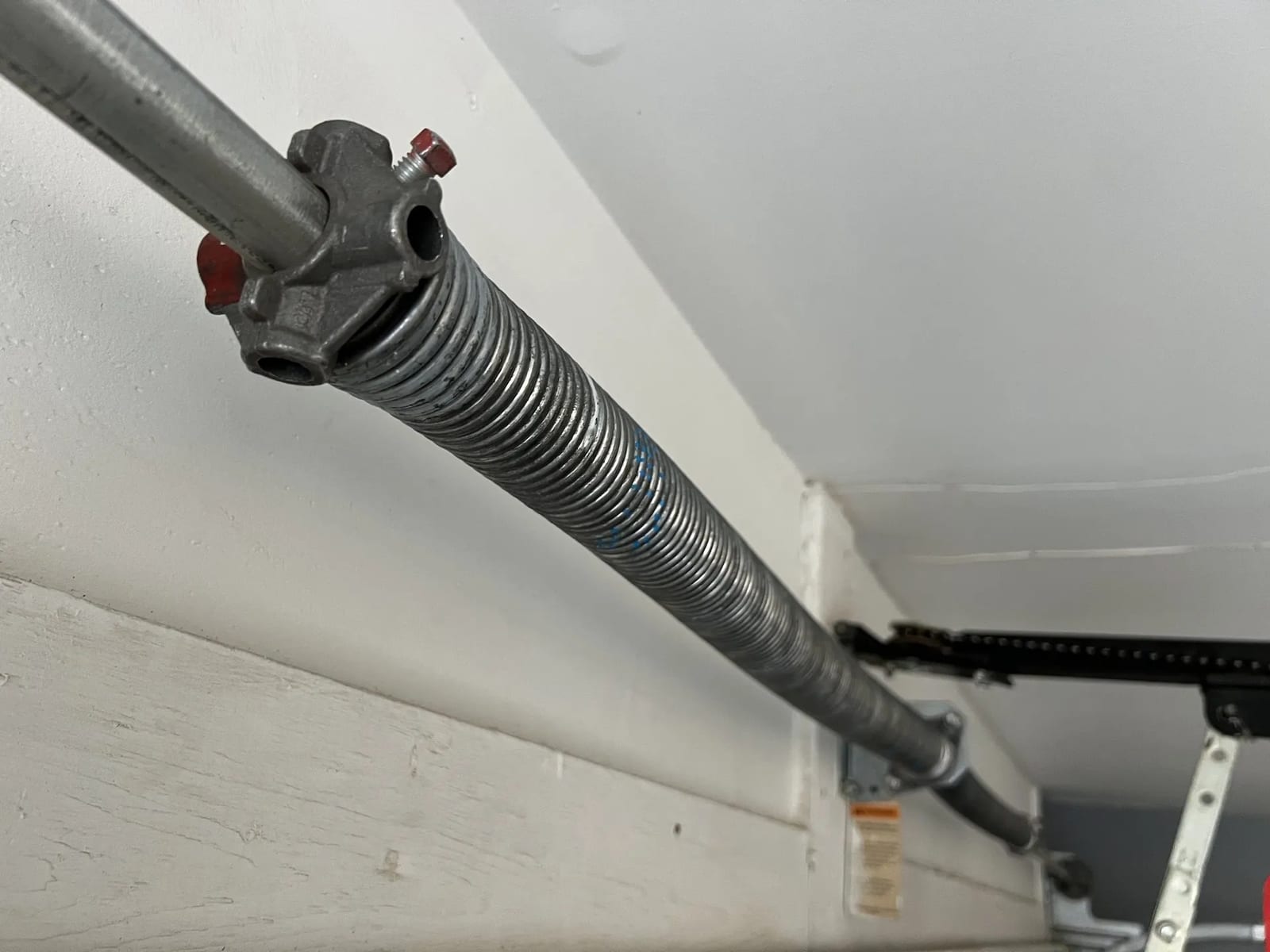 Close-up of a garage door torsion spring during a Morning Star repair